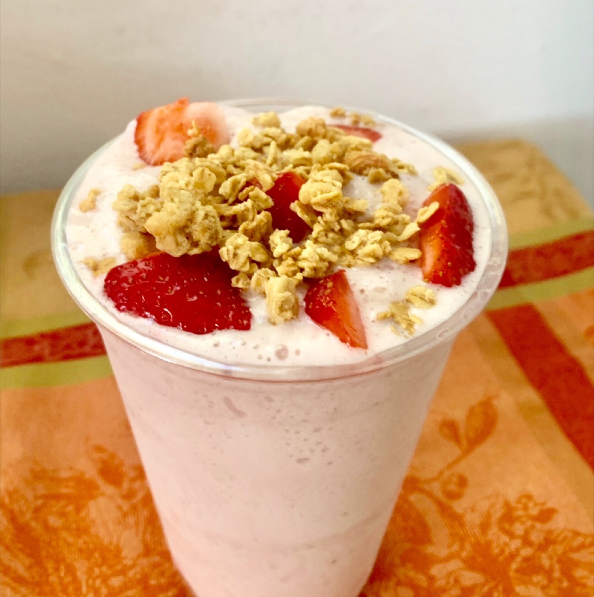 Fresh strawberry protein shake with granola